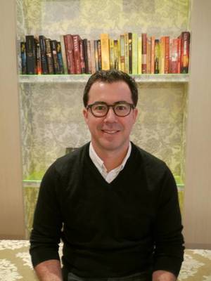 Brandon VanOver in front of a book shelf