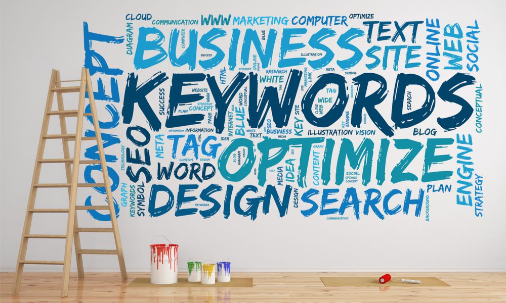 Paint cans, a ladder and blue paint on a wall with words like Keywords, Business, Search, SEO and Optimize.